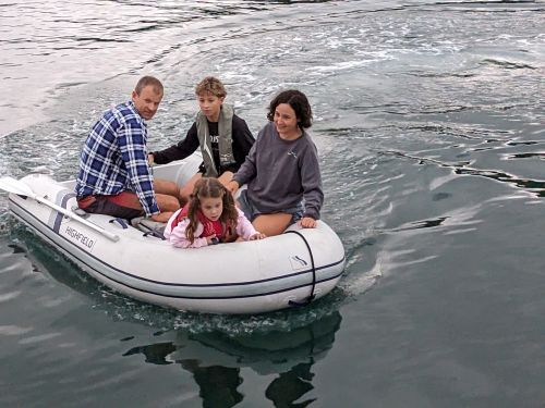 Theo steering the tender during Malua's 2024 family cruise