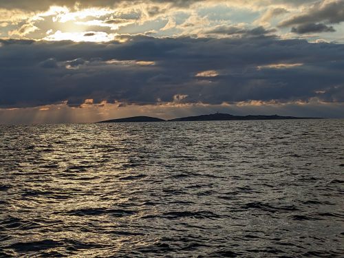 Montague Island silhouetted beneath clouds at sunrise